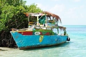 Old boat in the blue shallows of Belize