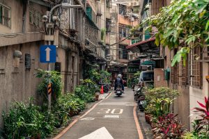 Small inner city road in Taipei with a moped riding it