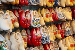 rows of brightly coloured clogs for sale