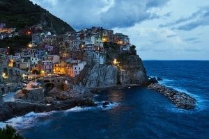 a town on a cliff top, looking over the Mediterranean Sea with waves crashing below