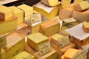 a cheese shop's huge selection of cheeses for sale