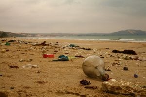 A beach littered with washed up plastic rubbish