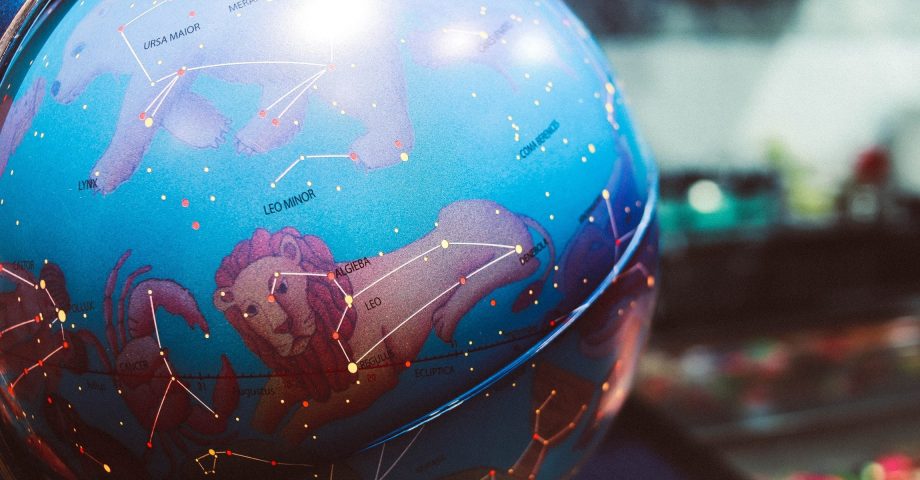 image of a globe with zodiac sign constellations