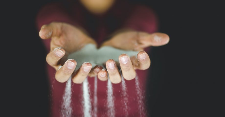 grains of sand falling through fingers