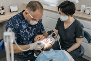 Dentist and nurse with patient