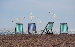 Empty deckchairs on an empty beach