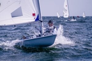 young man sailing a dingy in the sea