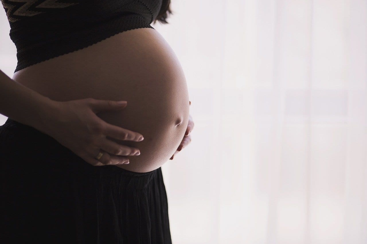 woman holding her pregnant tummy