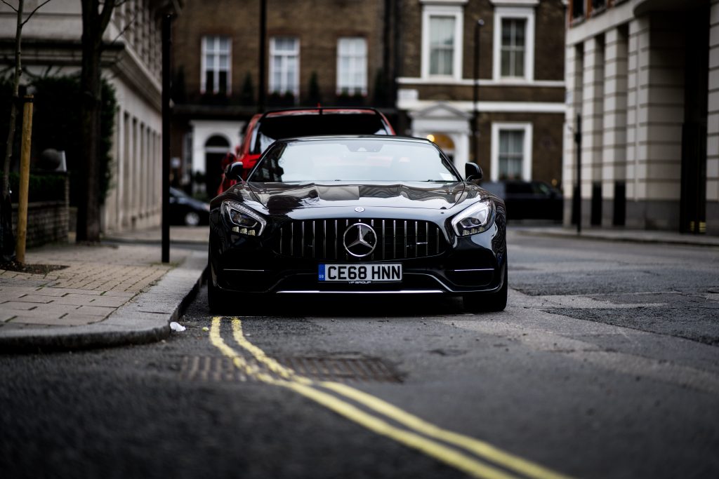 a black Mercedes Benz GT parked of double yellow lines in London