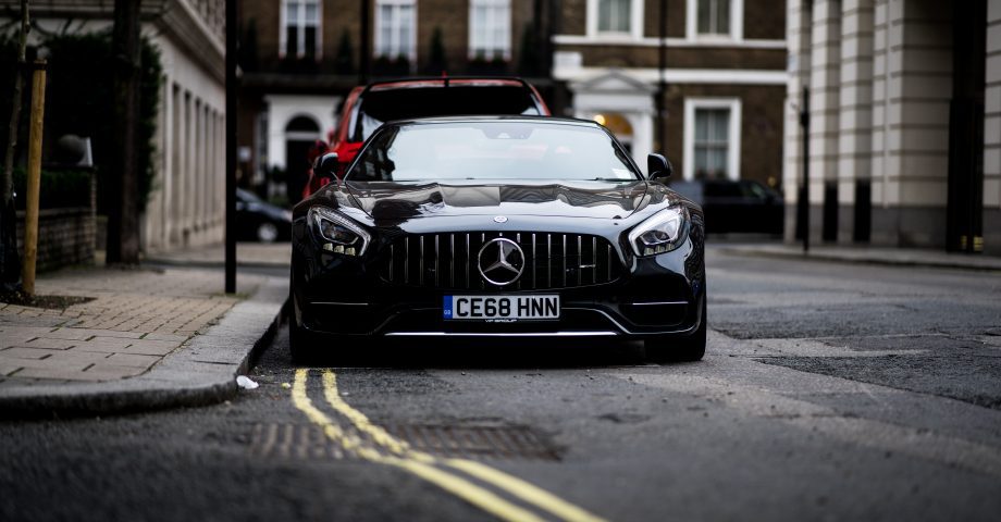 a black Mercedes Benz GT parked of double yellow lines in London