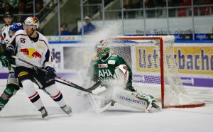 ice spray showering the ice hockey goal keeper