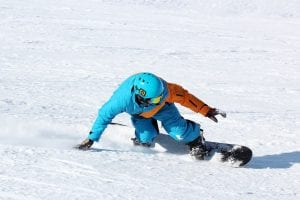 Snowboarder carving through the snow