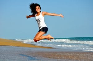 woman jumping on the beach