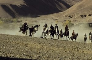 men on horseback playing a game of Buzkashi 