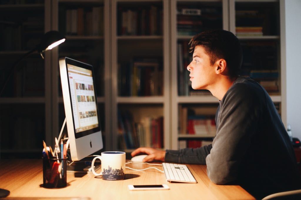 Man scrolling Youtube on computer