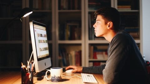 Man scrolling Youtube on computer