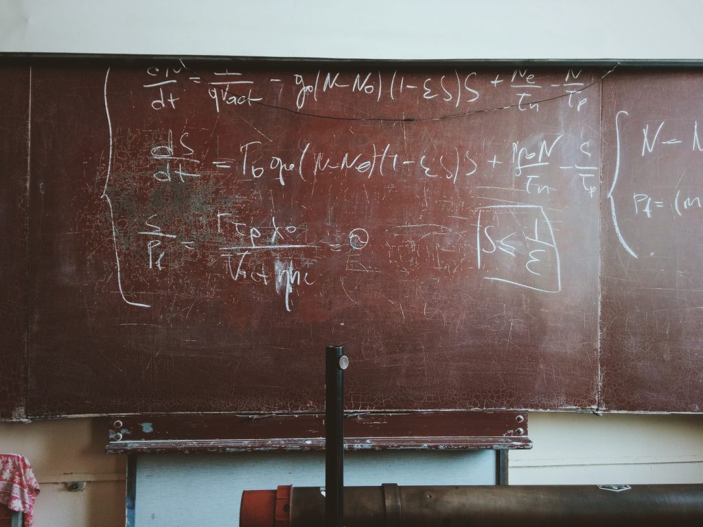 a classroom blackboard showing an mathematical equation