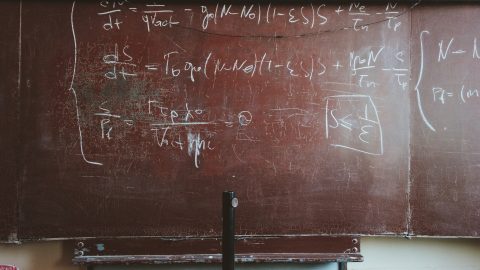 a classroom blackboard showing an mathematical equation