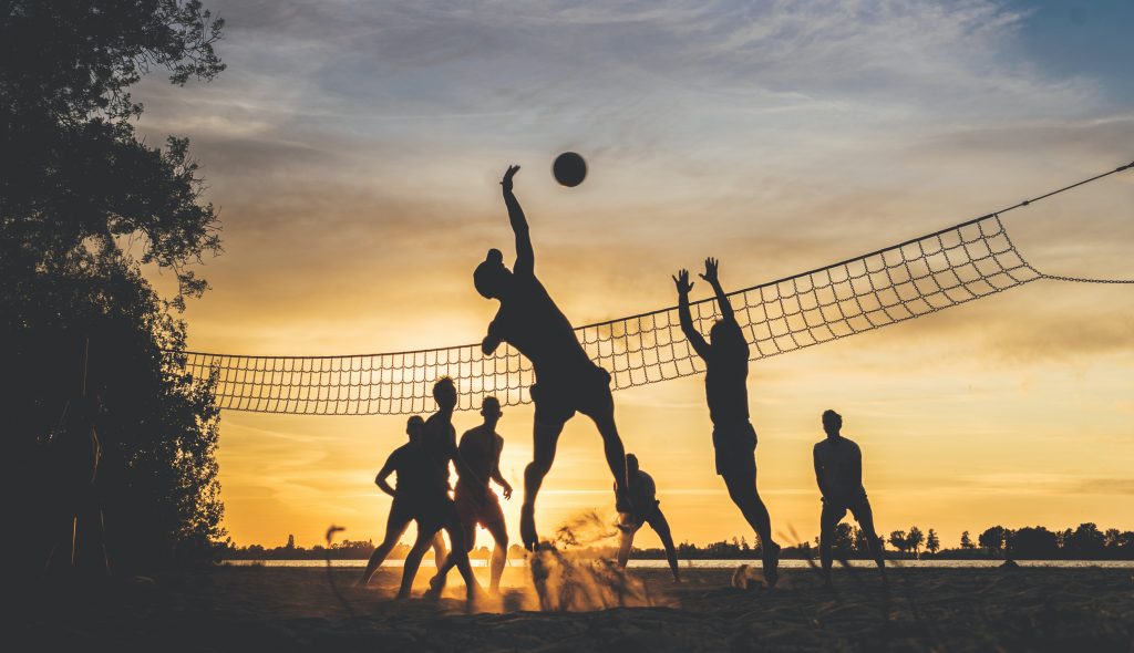 Friends playing volleyball